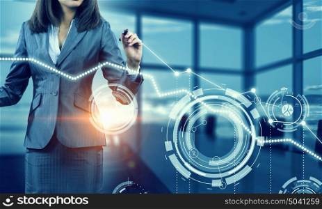 Woman using modern technologies for business. Chest view of businesswoman drawing infographs on screen