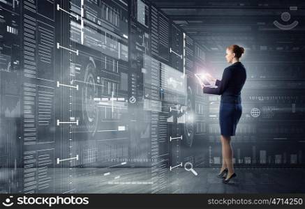 Woman using modern technologies. Full body of businesswoman with tablet pc against high tech background