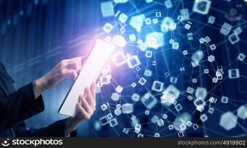 Woman using modern technologies. Hands of businesswoman with tablet pc against high tech background