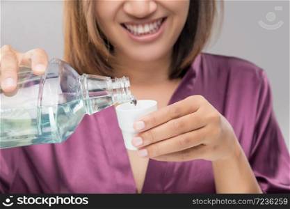 Woman Using Mouthwash After Brushing, Portrait Hands Pouring Mouthwash Into Bottle Cap, Dental Health Concepts