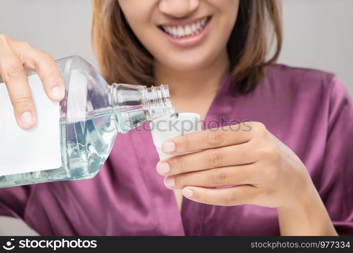 Woman Using Mouthwash After Brushing, Portrait Hands Pouring Mouthwash Into Bottle Cap, Dental Health Concepts