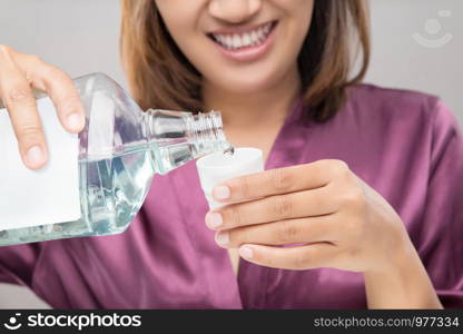 Woman Using Mouthwash After Brushing, Portrait Hands Pouring Mouthwash Into Bottle Cap, Dental Health Concepts