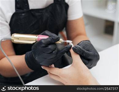 woman using nail file client
