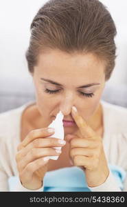 Woman using nasal drops