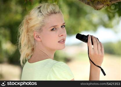 Woman using pair of binoculars