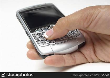 Woman using PDA, close-up of hand