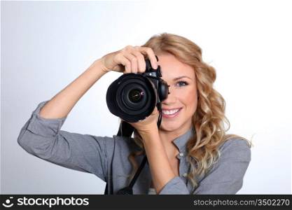 Woman using photo camera in studio