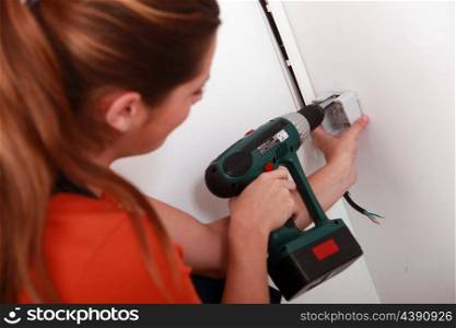 Woman using power drill