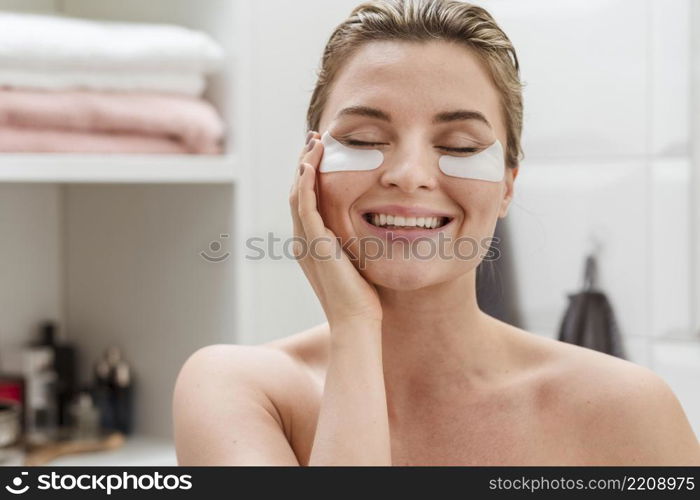 woman using reducing dark circles patches