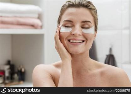 woman using reducing dark circles patches