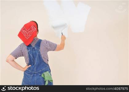 Woman using roller to paint the interior of her house