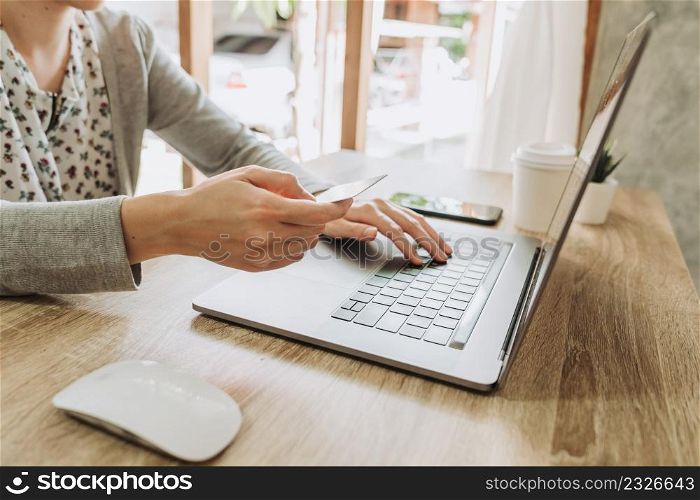 woman using smart phone and credit card for shopping online in coffee shop