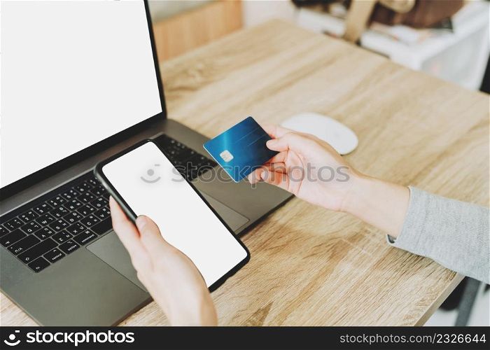 woman using smart phone and credit card for shopping online in coffee shop
