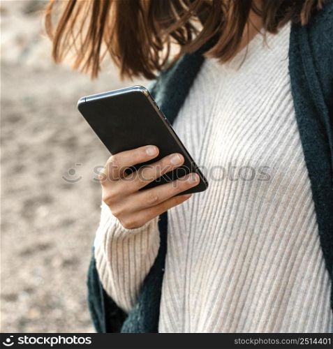 woman using smartphone beach