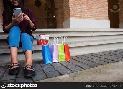 Woman using smartphone for shopping online, shopping concept.