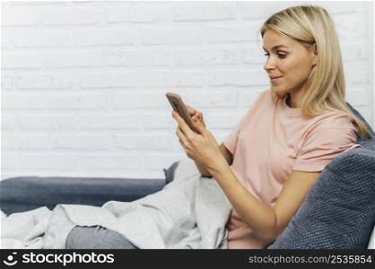 woman using smartphone home during pandemic with copy space