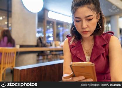 woman using smartphone in the cafe