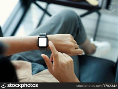 woman using smartwatch blank screen on top view