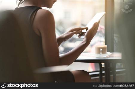 woman using tablet in coffee shop