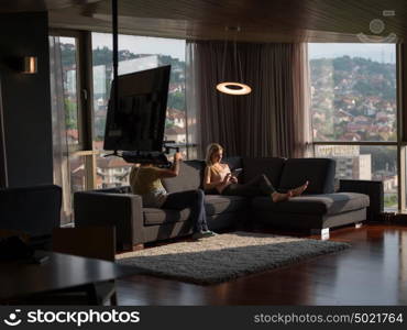 woman using technology on sofa in modern apartment