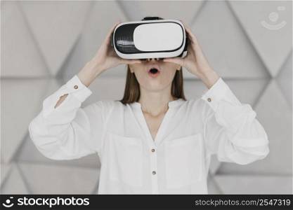 woman using virtual reality headset being amazed