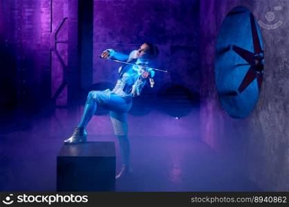 Woman violinist performing electronic music on violin. Talented female artist entertainment over atmospheric background in neon illumination. Young woman violinist performing electronic music on violin