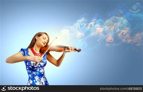 Woman violinist. Young attractive woman in blue dress playing violin