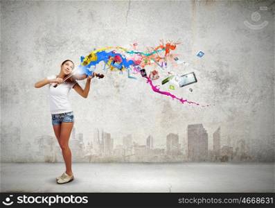 Woman violinist. Young attractive woman in casual playing violin