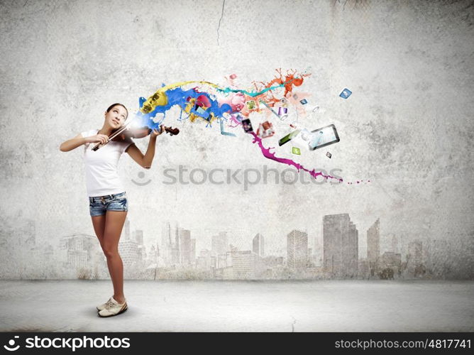 Woman violinist. Young attractive woman in casual playing violin