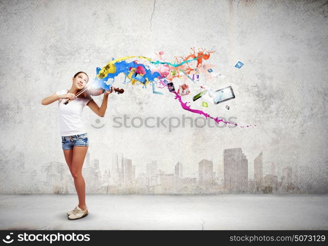 Woman violinist. Young attractive woman in casual playing violin