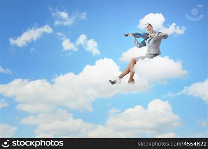 Woman violinist. Young businesswoman sitting on cloud and playing violin
