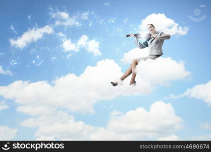 Woman violinist. Young businesswoman sitting on cloud and playing violin