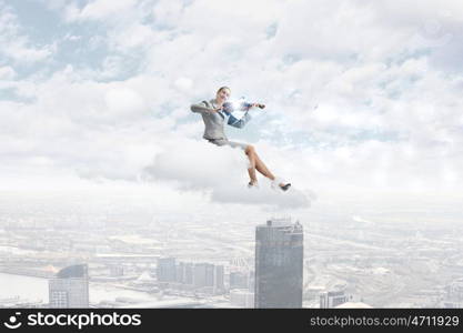 Woman violinist. Young businesswoman sitting on cloud and playing violin