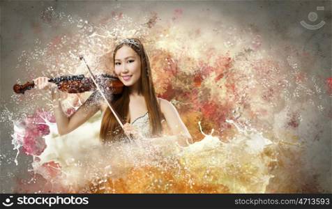 Woman violinist. Young pretty asian woman playing violin. Young talent