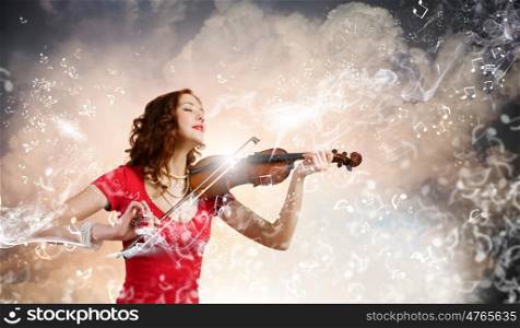 Woman violinist. Young pretty woman in red dress playing violin