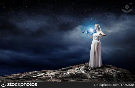 Woman violinist. Young woman in white dress playing violin
