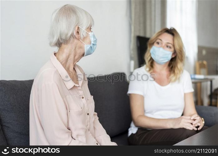 woman visiting her relative nursing home wearing medical mask