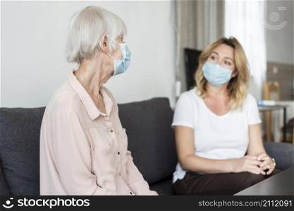 woman visiting her relative nursing home wearing medical mask