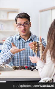 Woman visiting jeweler for jewelery evaluation