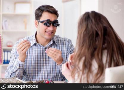 Woman visiting jeweler for jewelery evaluation