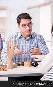 Woman visiting jeweler for jewelery evaluation