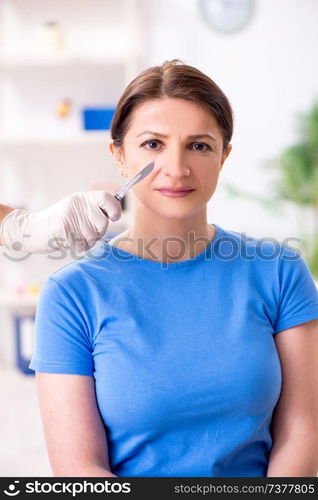 Woman visiting male doctor for plastic surgery  