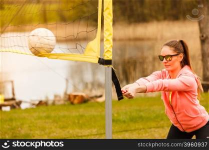 Woman volleyball player outdoor on court. Sports games and people concept. Young woman in sportswear volleyball player in action outdoor on court