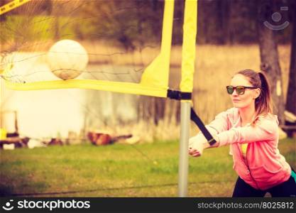 Woman volleyball player outdoor on court. Sports games and people concept. Young woman in sportswear volleyball player in action outdoor on court