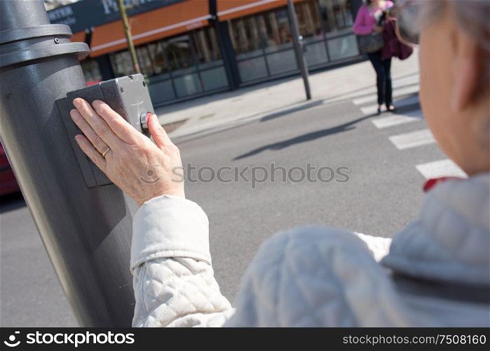 woman wait for crossing road with crossing button