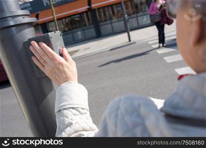 woman wait for crossing road with crossing button