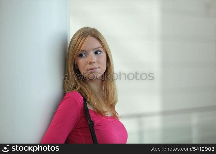 Woman waiting in a corridor