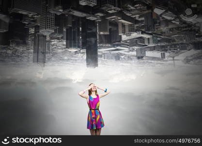 Woman waiting surprise. Young woman in multicolored dress covering eyes with hands