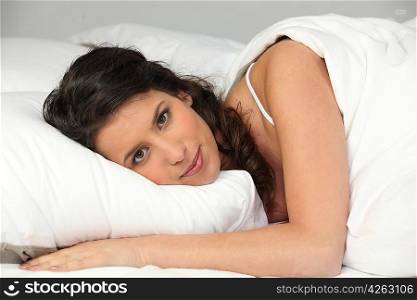 Woman waking up in bed