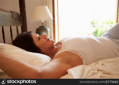 Woman Waking Up In Bed In Morning